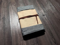 a folded piece of cloth sitting on top of a wooden floor