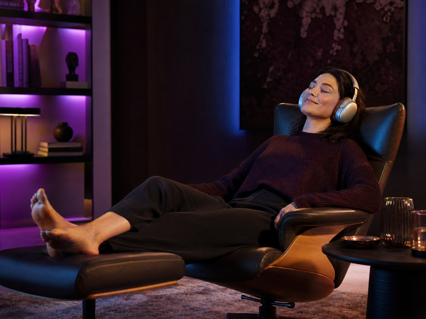 Person reclining comfortably in a chair while using Melody Chat through headphones