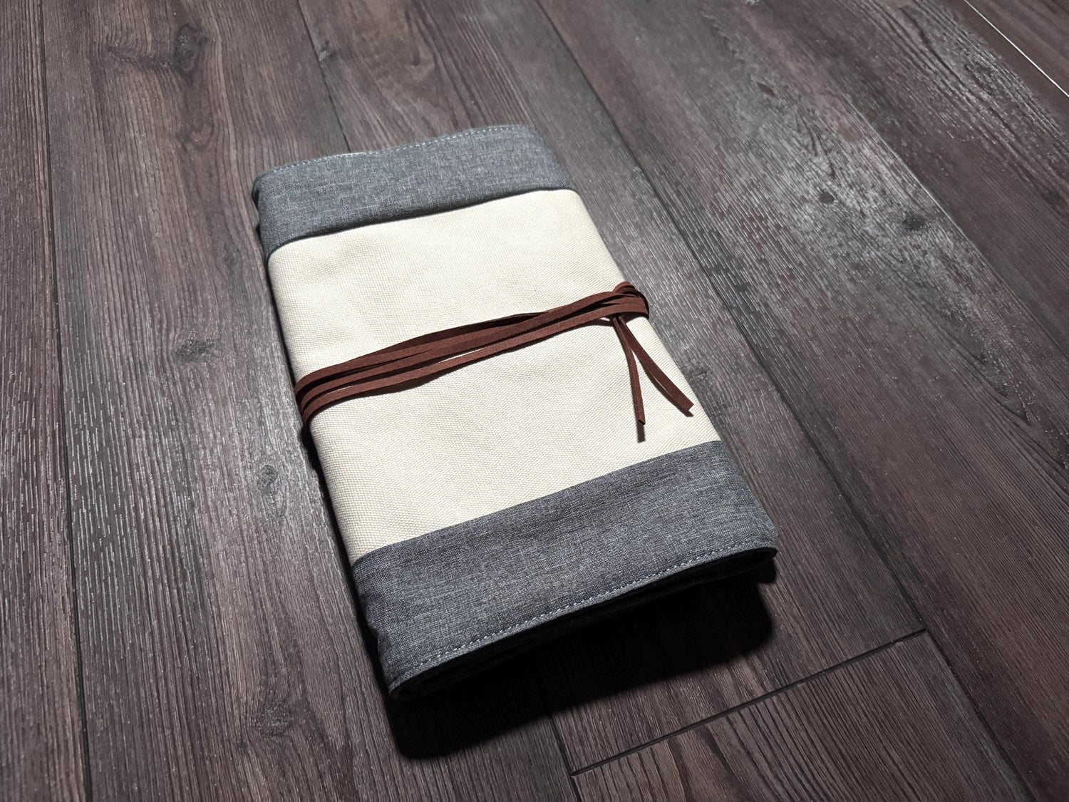 a folded piece of cloth on a wooden floor