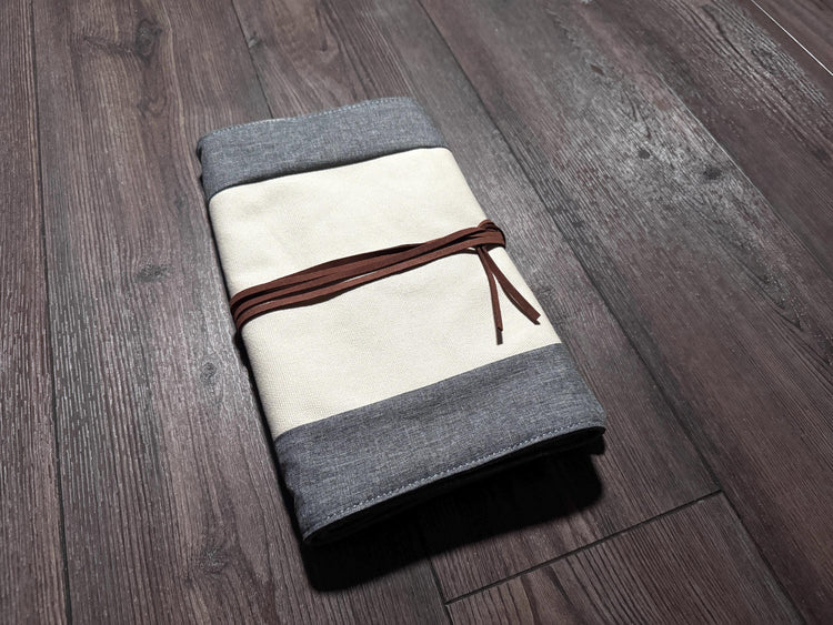 a folded piece of cloth on a wooden floor