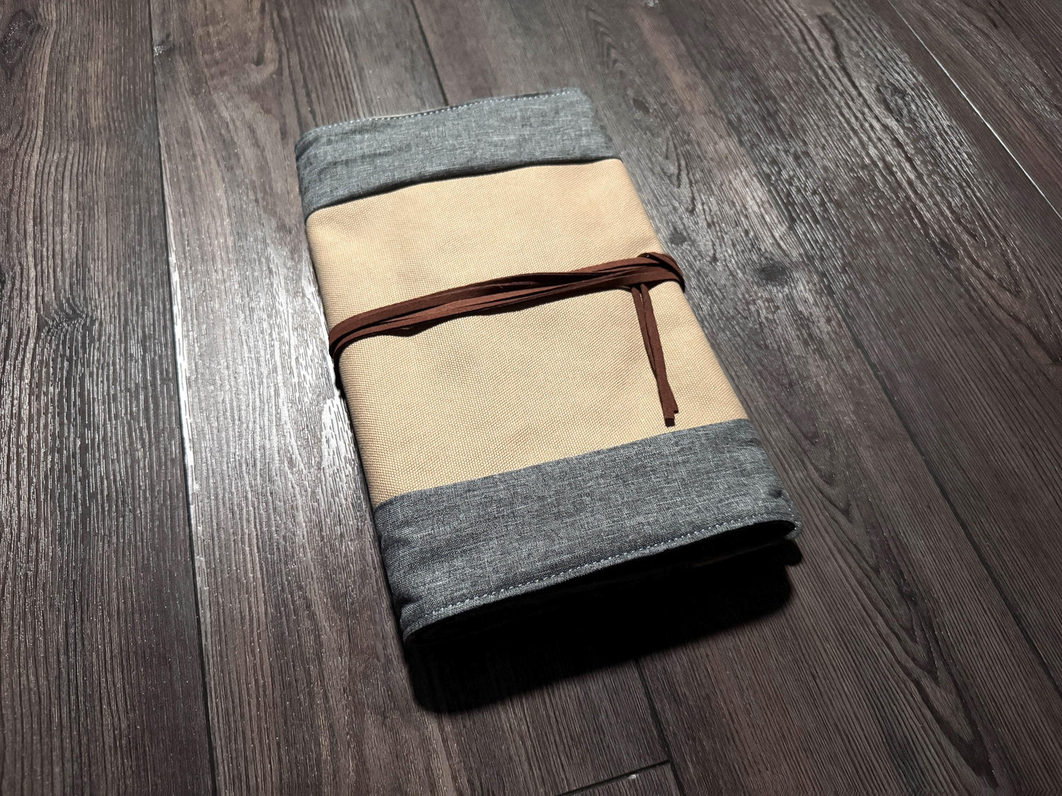 a folded piece of cloth sitting on top of a wooden floor