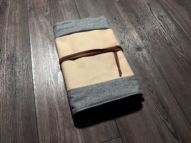 a folded piece of cloth sitting on top of a wooden floor