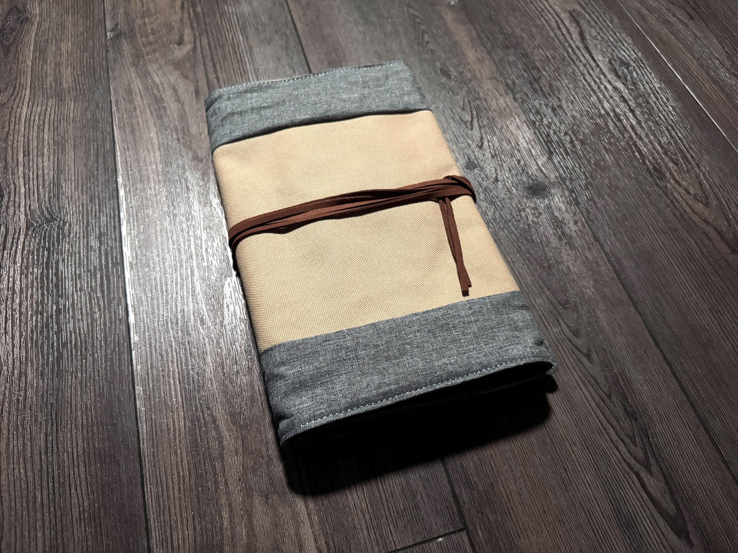 a folded piece of cloth sitting on top of a wooden floor