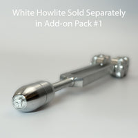 A close-up view of a silver-colored metal object, possibly a tool or device, with a text overlay that reads "White Howlite Sold Separately in Add-on Pack #1".
