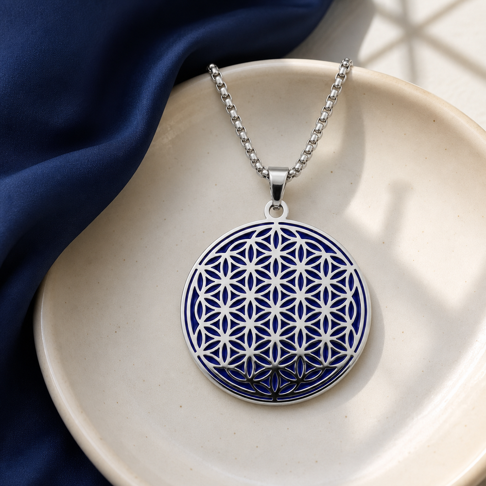 Indigo and silver Flower of Life charm necklace on ceramic and indigo fabric