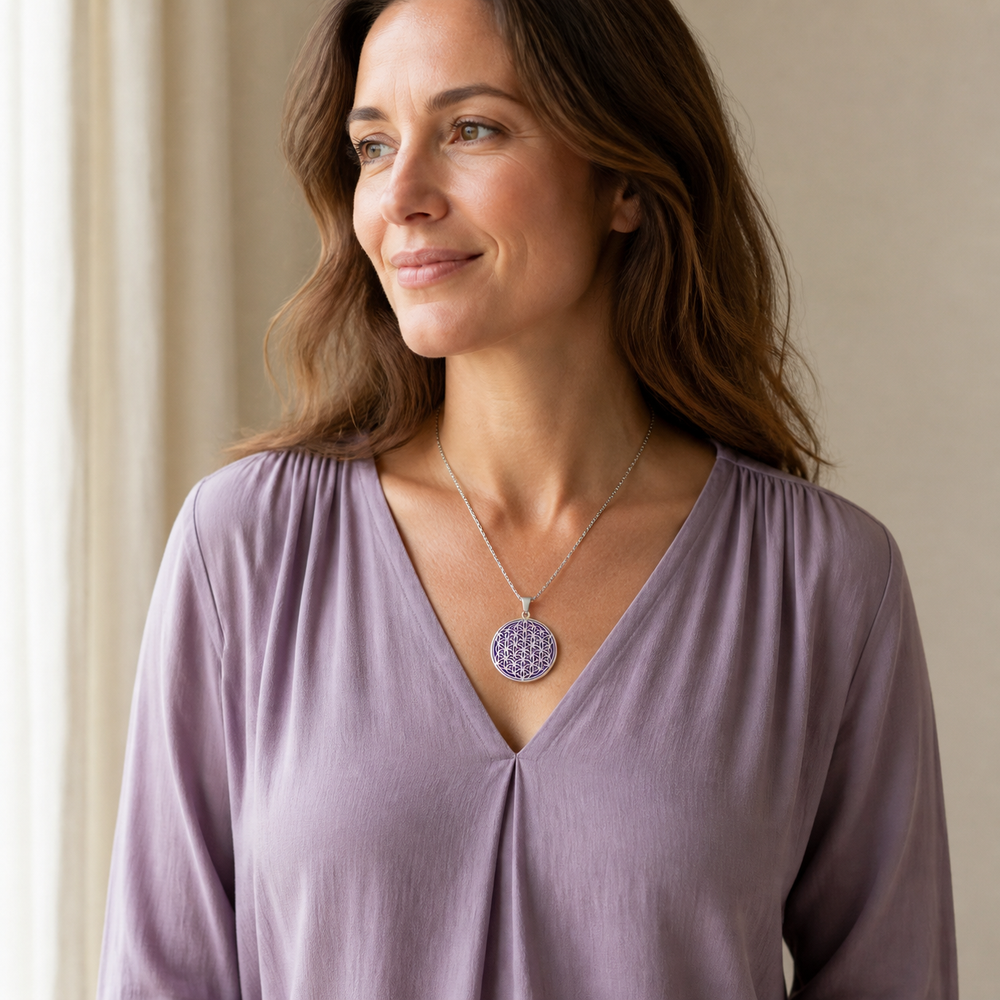 Purple and silver Flower of Life charm necklace worn with a lilac blouse